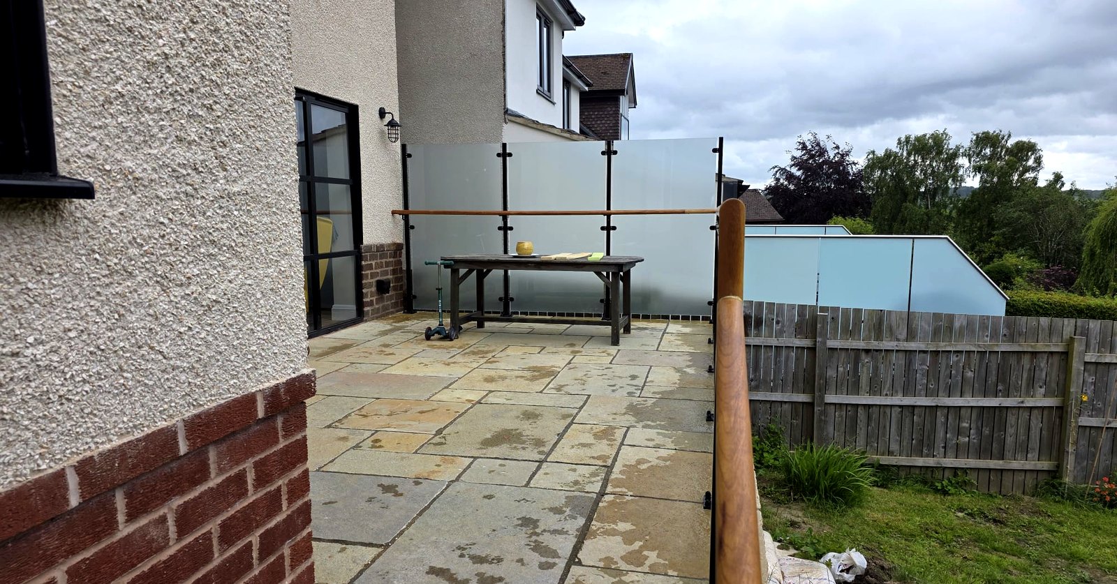 Black metal railings and frosted glass privacy screen on a terrace, Bradway, Sheffield